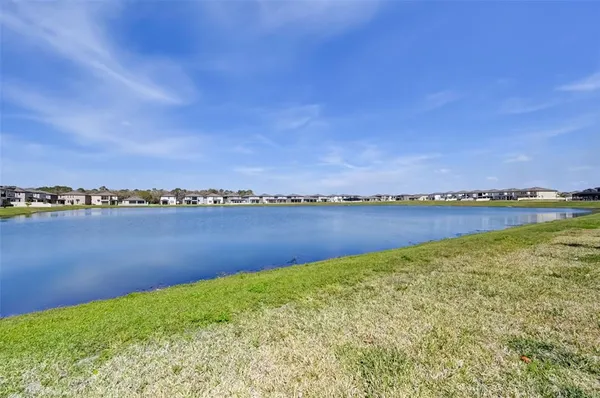 a view of a lake with houses in the back