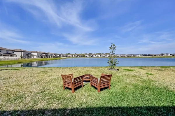 a view of a swimming pool with seating area and hardwood floor