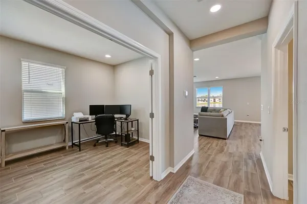 a view of a workspace with wooden floor and a bathroom