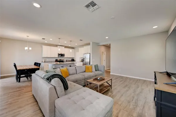 a living room with furniture and kitchen view
