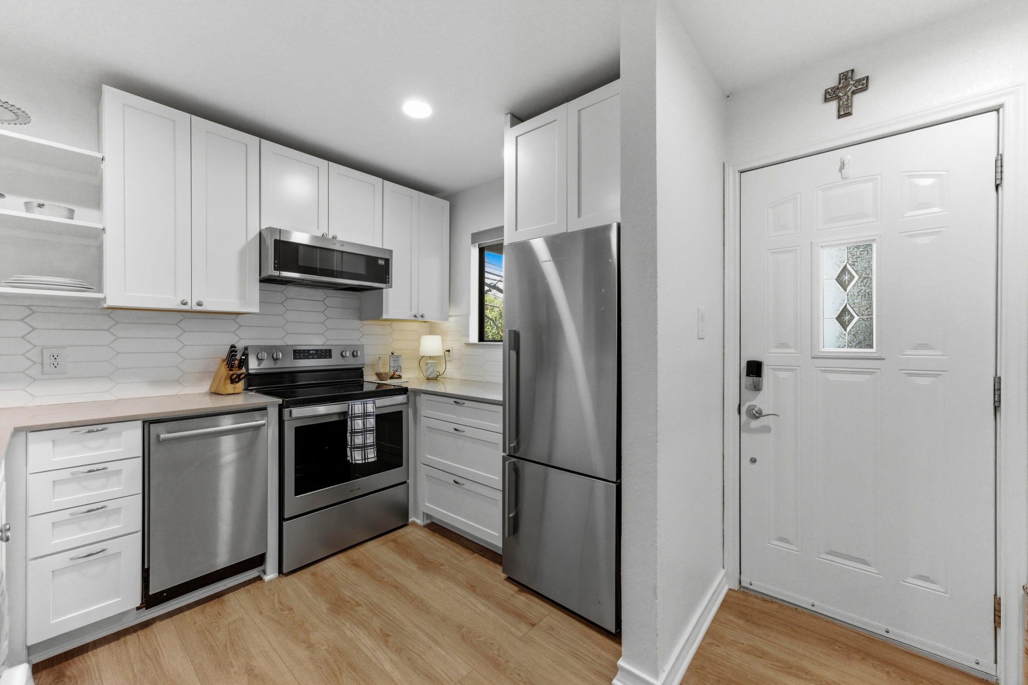 2605 Enfield Road, Unit 218 Austin, TX 78703 - Photo 12 of 26 a kitchen with stainless steel appliances a refrigerator sink and microwave
