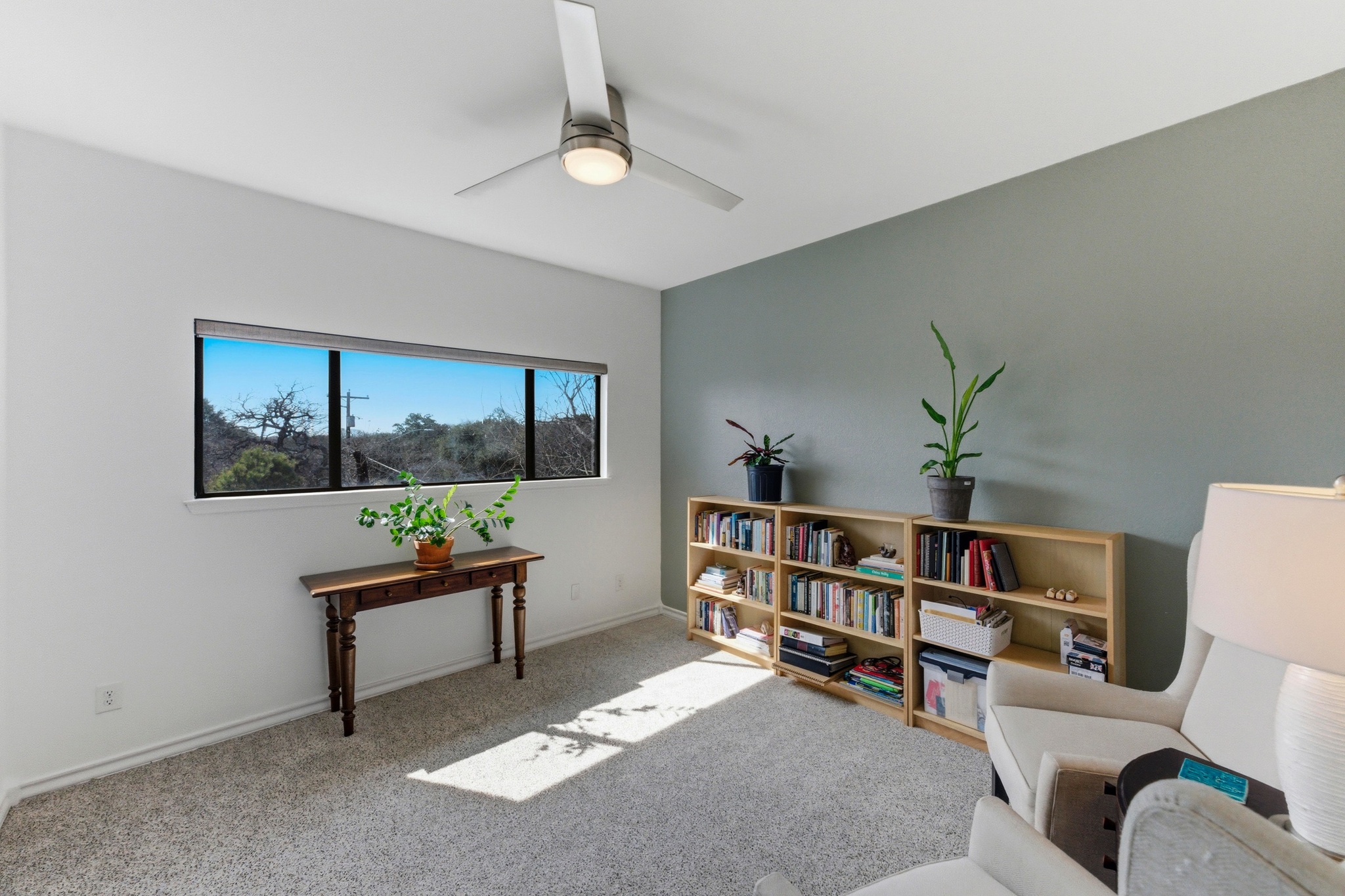 2605 Enfield Road, Unit 218 Austin, TX 78703 - Photo 15 of 26 a workspace with a bookshelf