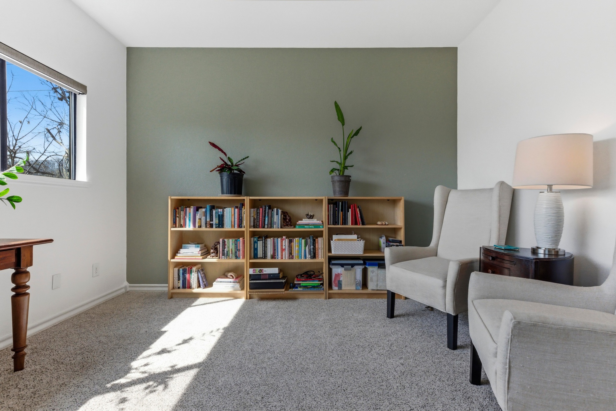 2605 Enfield Road, Unit 218 Austin, TX 78703 - Photo 17 of 26 a living room with furniture and a book shelf