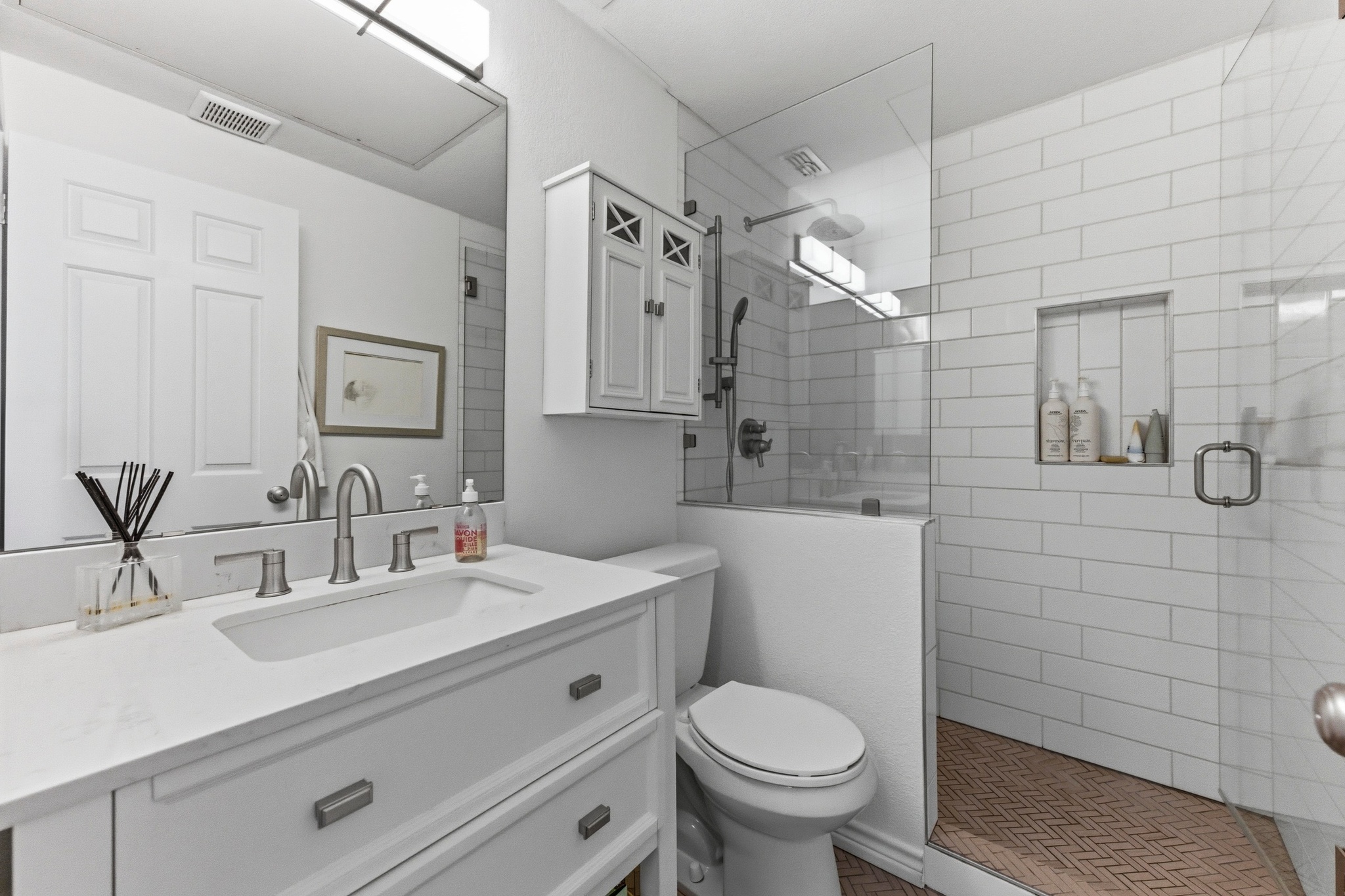 2605 Enfield Road, Unit 218 Austin, TX 78703 - Photo 21 of 26 a bathroom with a sink a toilet and shower