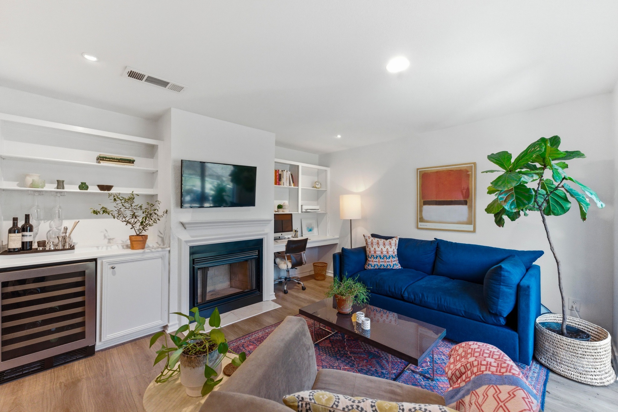 2605 Enfield Road, Unit 218 Austin, TX 78703 - Photo 4 of 26 a living room with furniture a fireplace and a potted plant