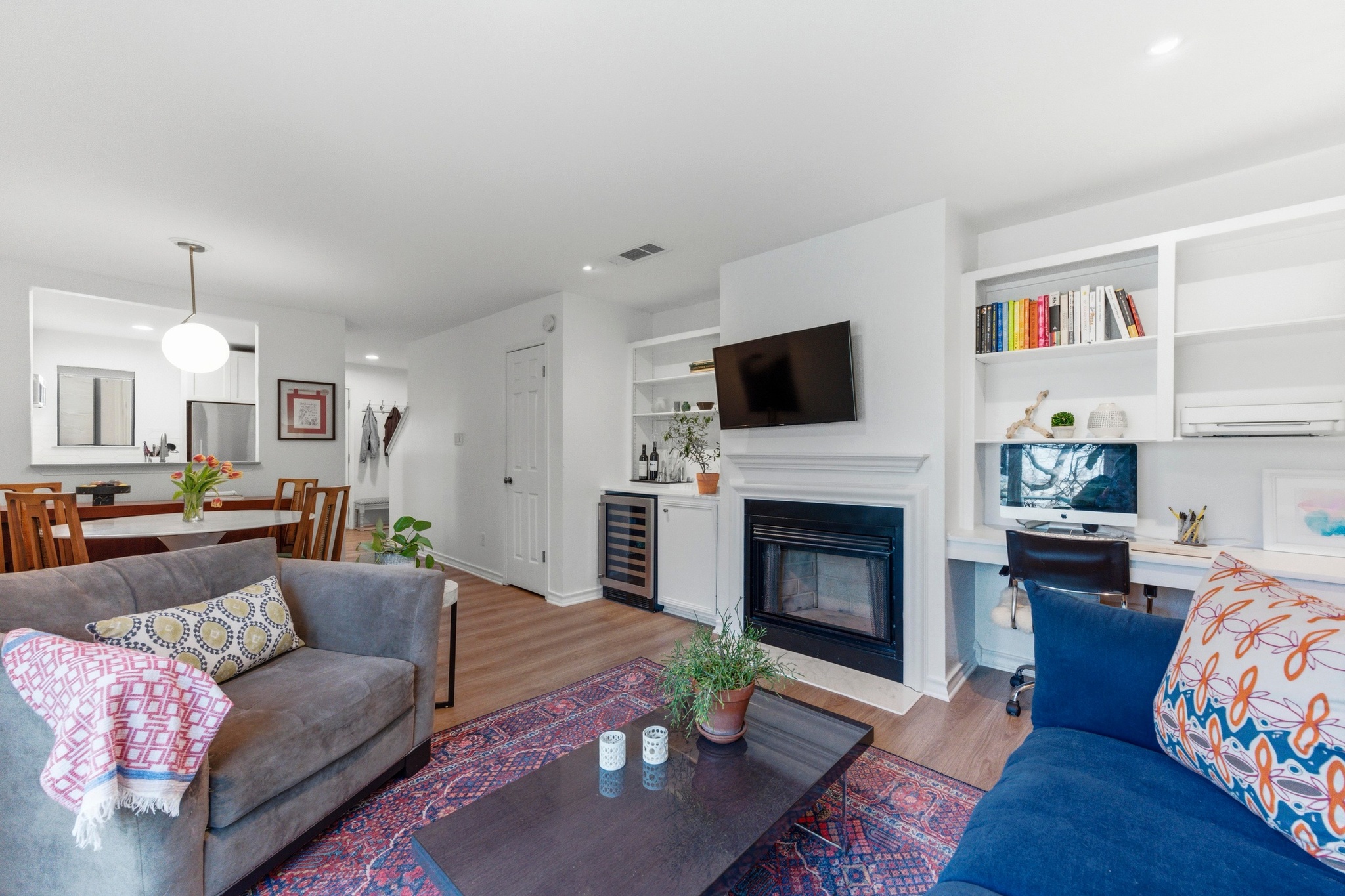 2605 Enfield Road, Unit 218 Austin, TX 78703 - Photo 7 of 26 a living room with furniture a fireplace and a flat screen tv