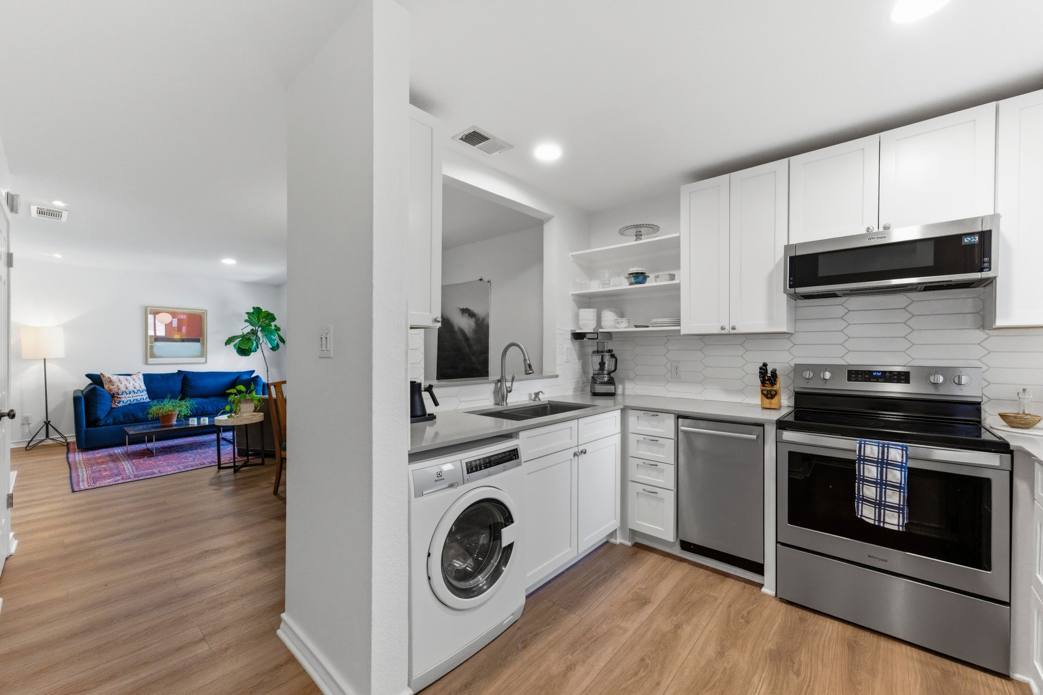 2605 Enfield Road, Unit 218 Austin, TX 78703 - Photo 9 of 26 a kitchen with a stove a microwave and cabinets
