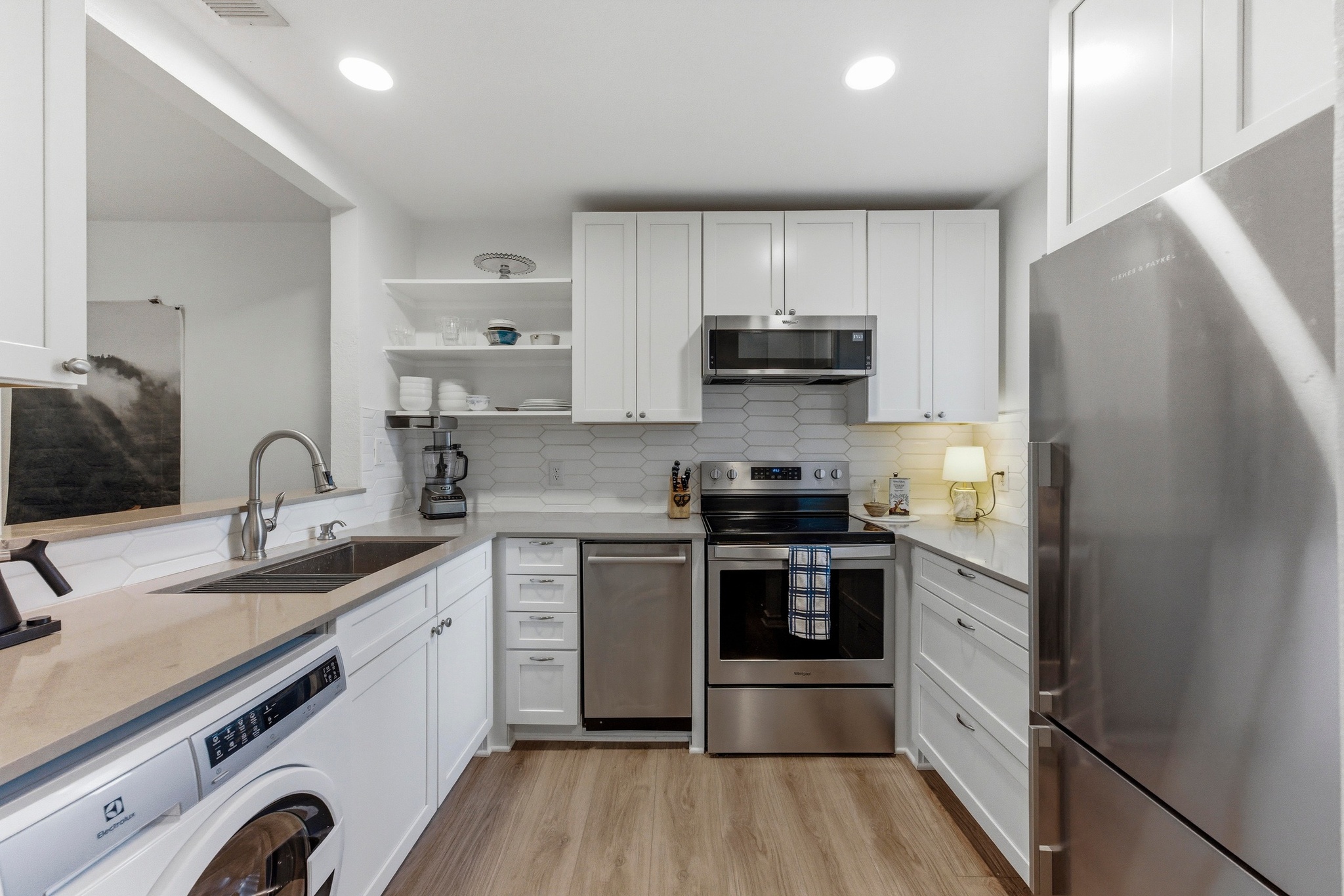 2605 Enfield Road, Unit 218 Austin, TX 78703 - Photo 10 of 26 a kitchen with stainless steel appliances a sink cabinets and a counter top space