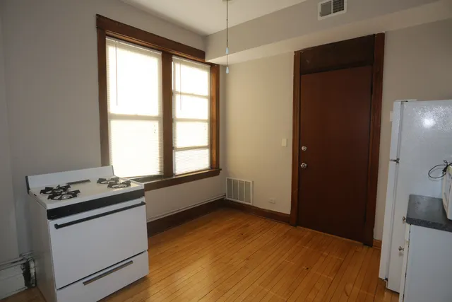 a kitchen with granite countertop a stove and a window