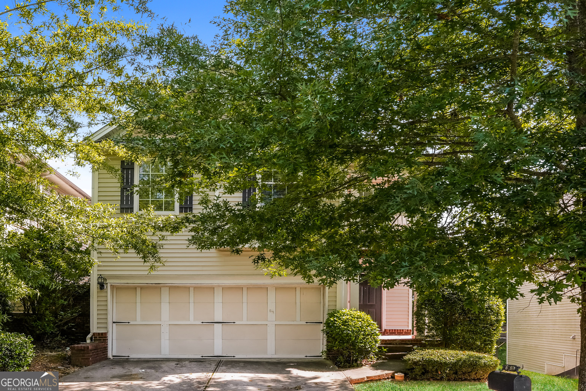 a front view of a house with a garden