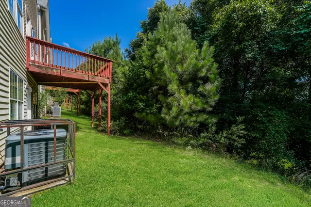 a view of backyard with a garden and deck