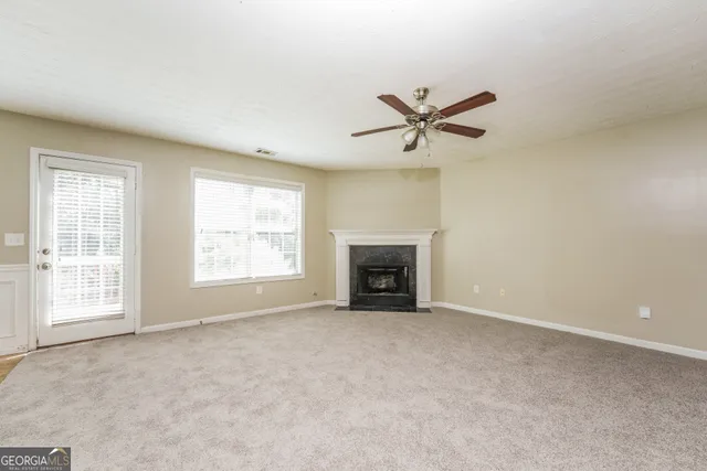 an empty room with closet and fan