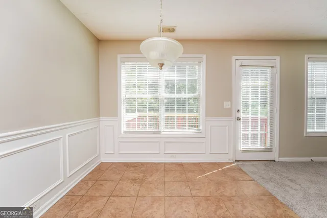 a kitchen with stainless steel appliances granite countertop a refrigerator a sink and a stove