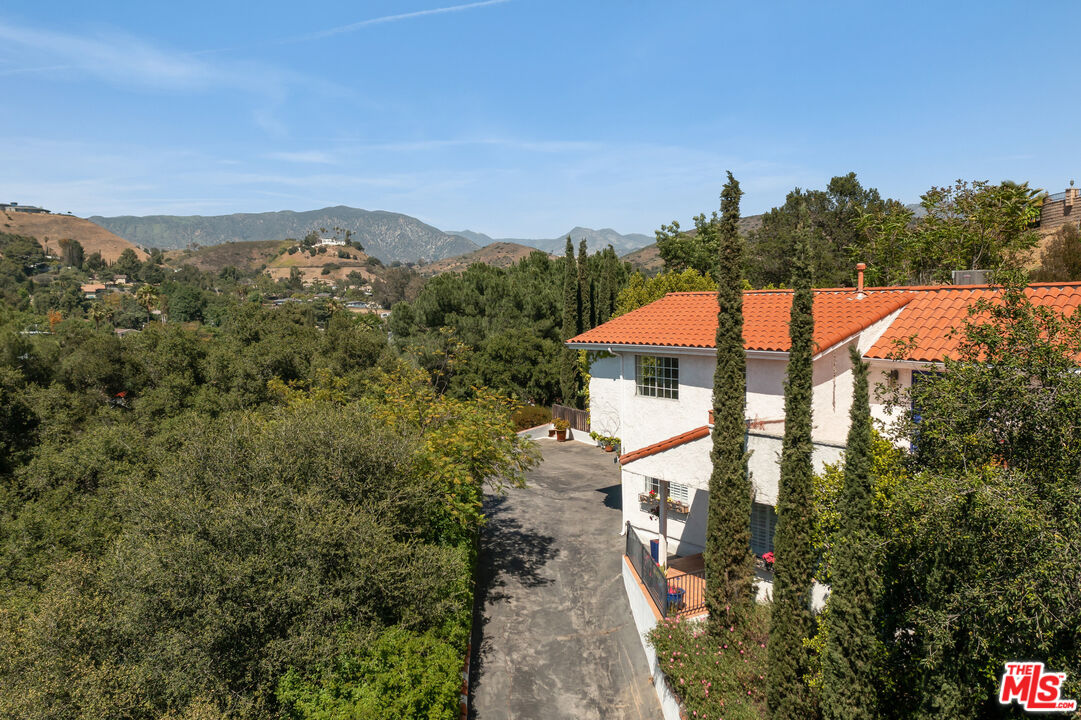 a view of a house with a yard and mountain
