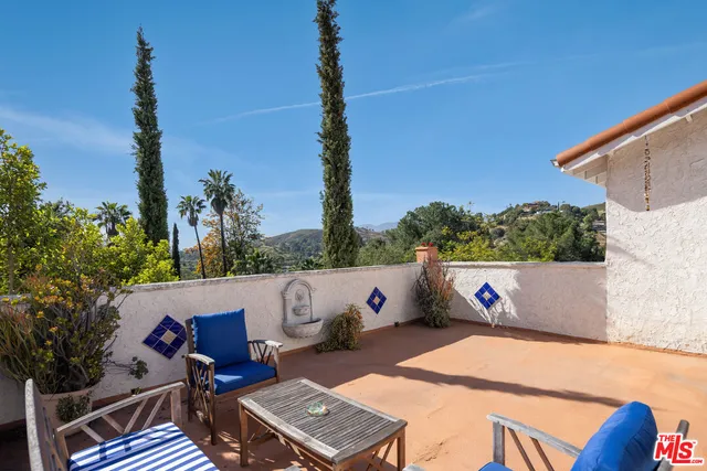 a bathroom with a toilet sink vanity and mirror
