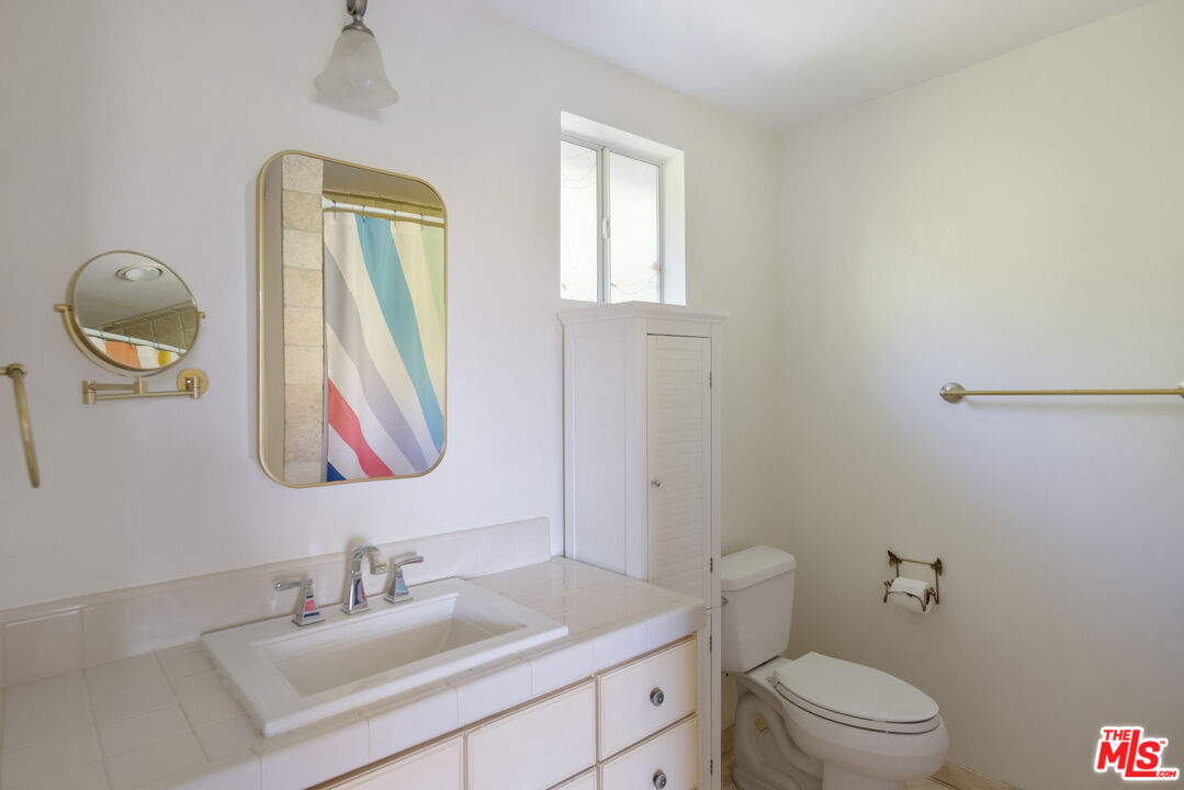 9732 Rotta Avenue Sunland, CA 91040 - Photo 12 of 22 a bathroom with a toilet sink vanity and mirror