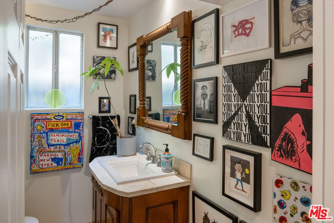 9732 Rotta Avenue Sunland, CA 91040 - Photo 15 of 22 a bathroom with a sink a vanity and painting on the wall