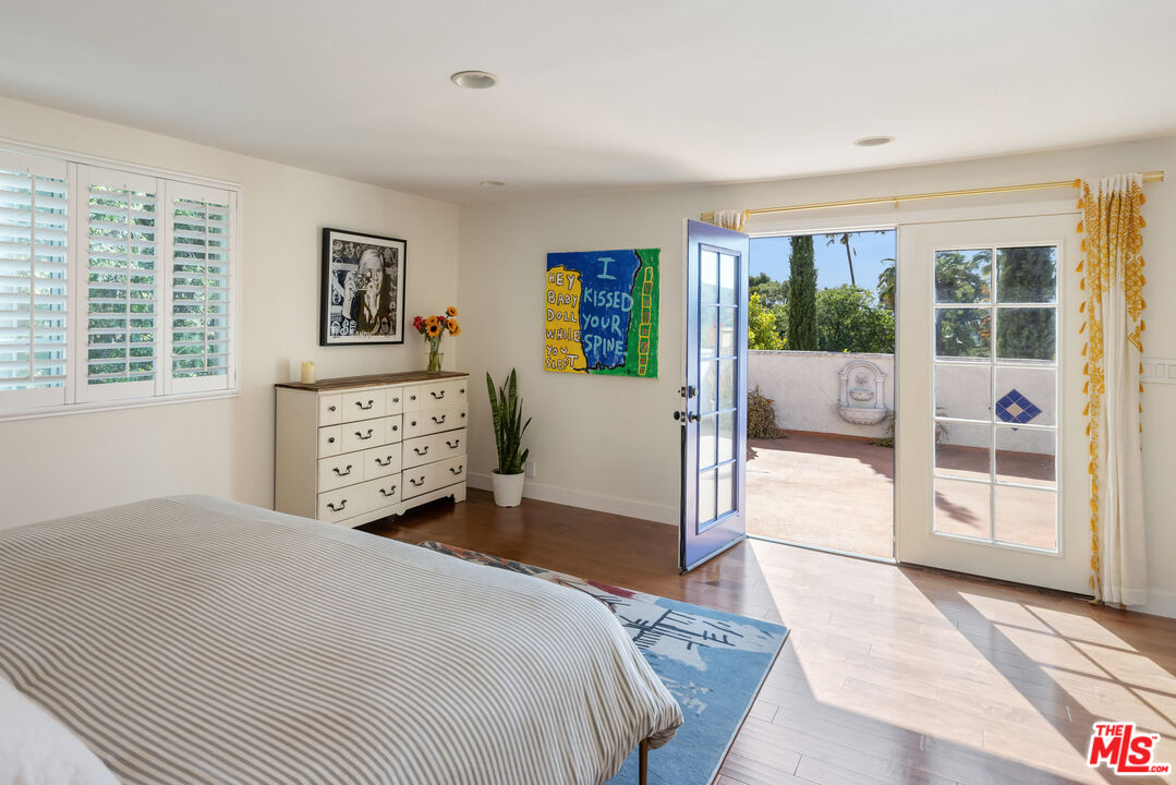 9732 Rotta Avenue Sunland, CA 91040 - Photo 10 of 22 a bedroom with a large bed and a large window