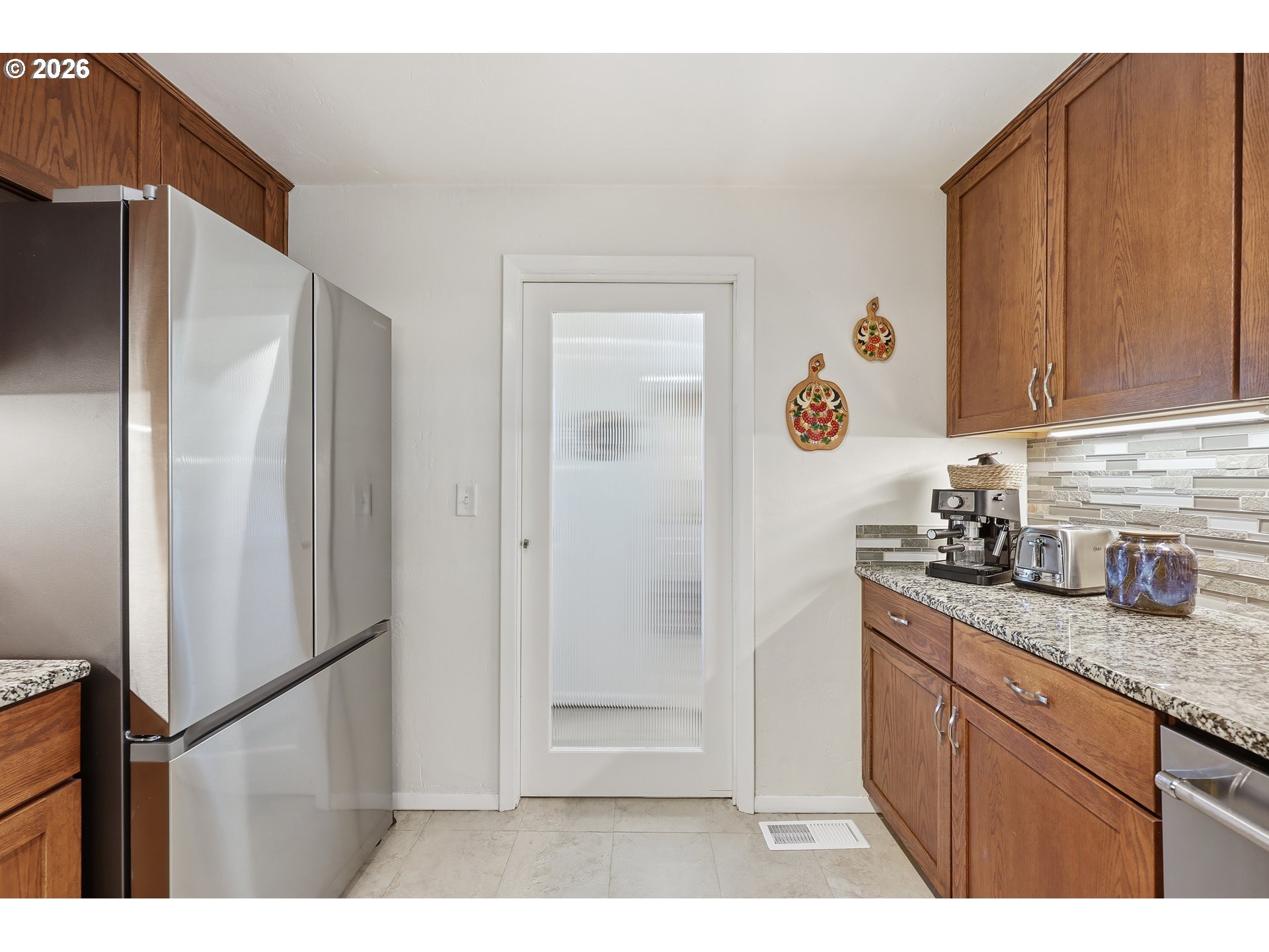 65 Greenvale Drive Springfield, OR 97477 - Photo 16 of 42 a kitchen with granite countertop a refrigerator and a sink