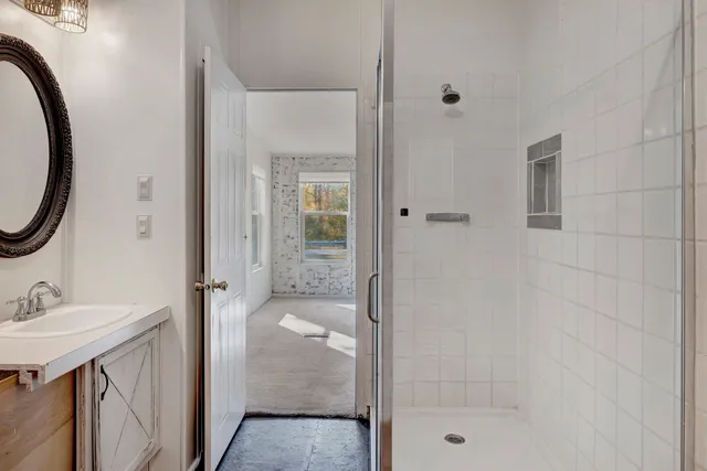a view of an empty room with a chandelier fan