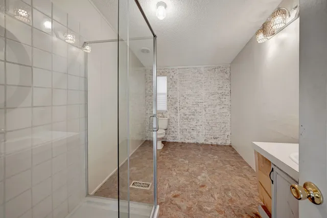 a bathroom with a sink a toilet and a mirror