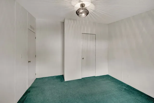 a bathroom with a black white checkered floor