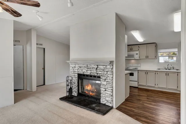 a kitchen with granite countertop a refrigerator stove and sink