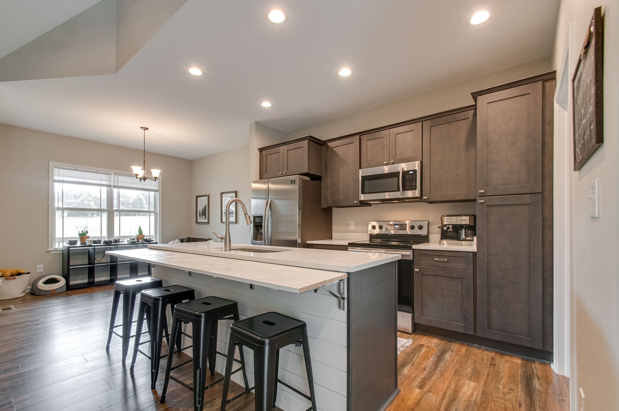 114 Black Road Dickson, TN 37055 - Photo 8 of 29 a kitchen with stainless steel appliances granite countertop a refrigerator a stove a sink a dining table and chairs