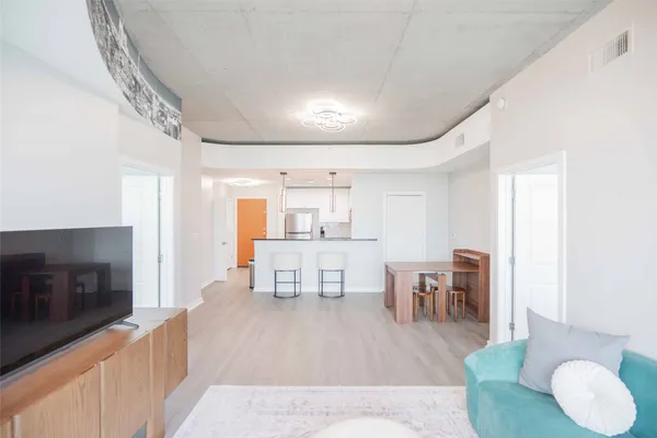 a living room with furniture and a wooden floor