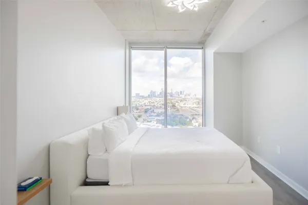 a bed sitting in a bedroom next to a window