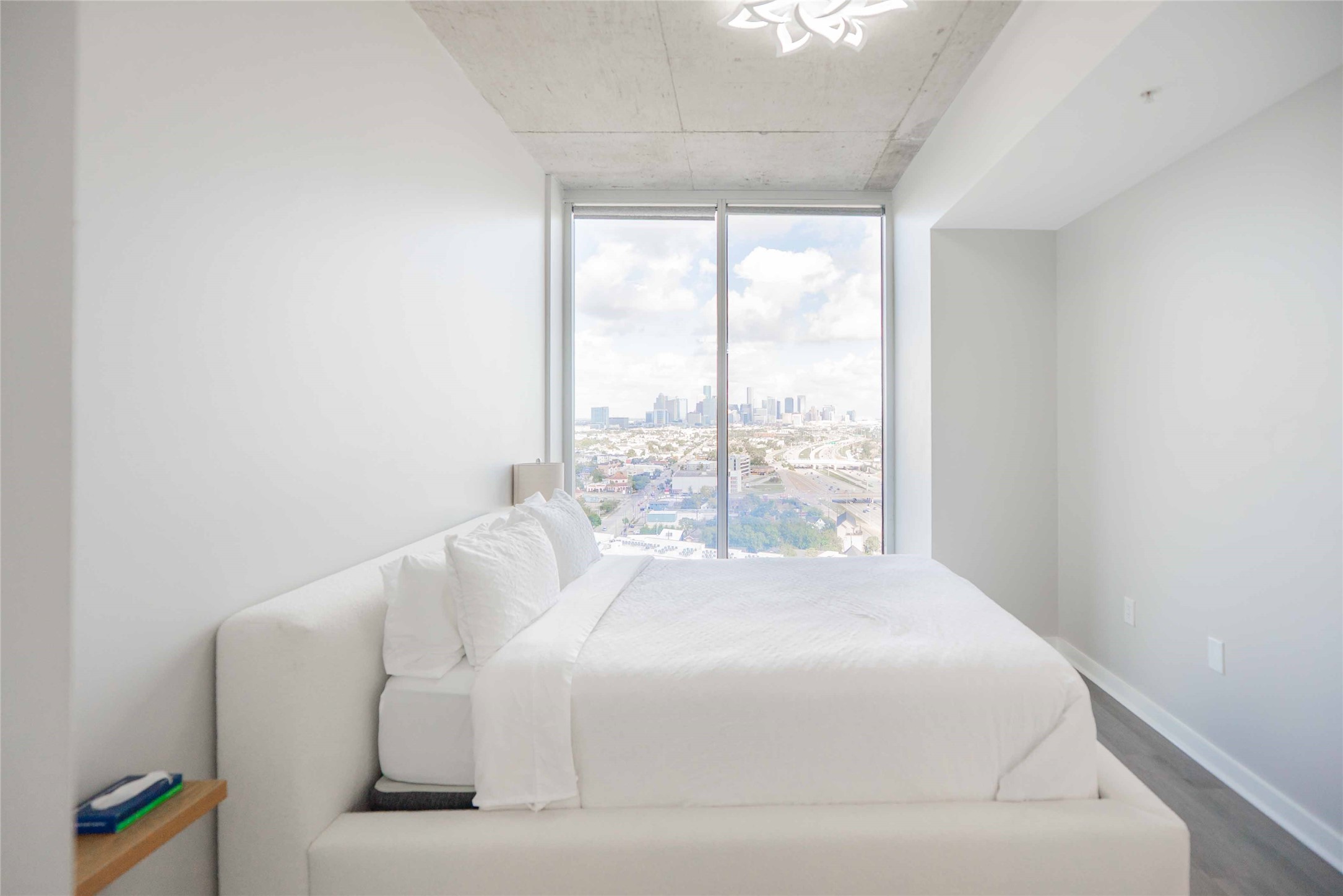 5925 Almeda Road, Unit 12005 Houston, TX 77004 - Photo 14 of 25 a bed sitting in a bedroom next to a window