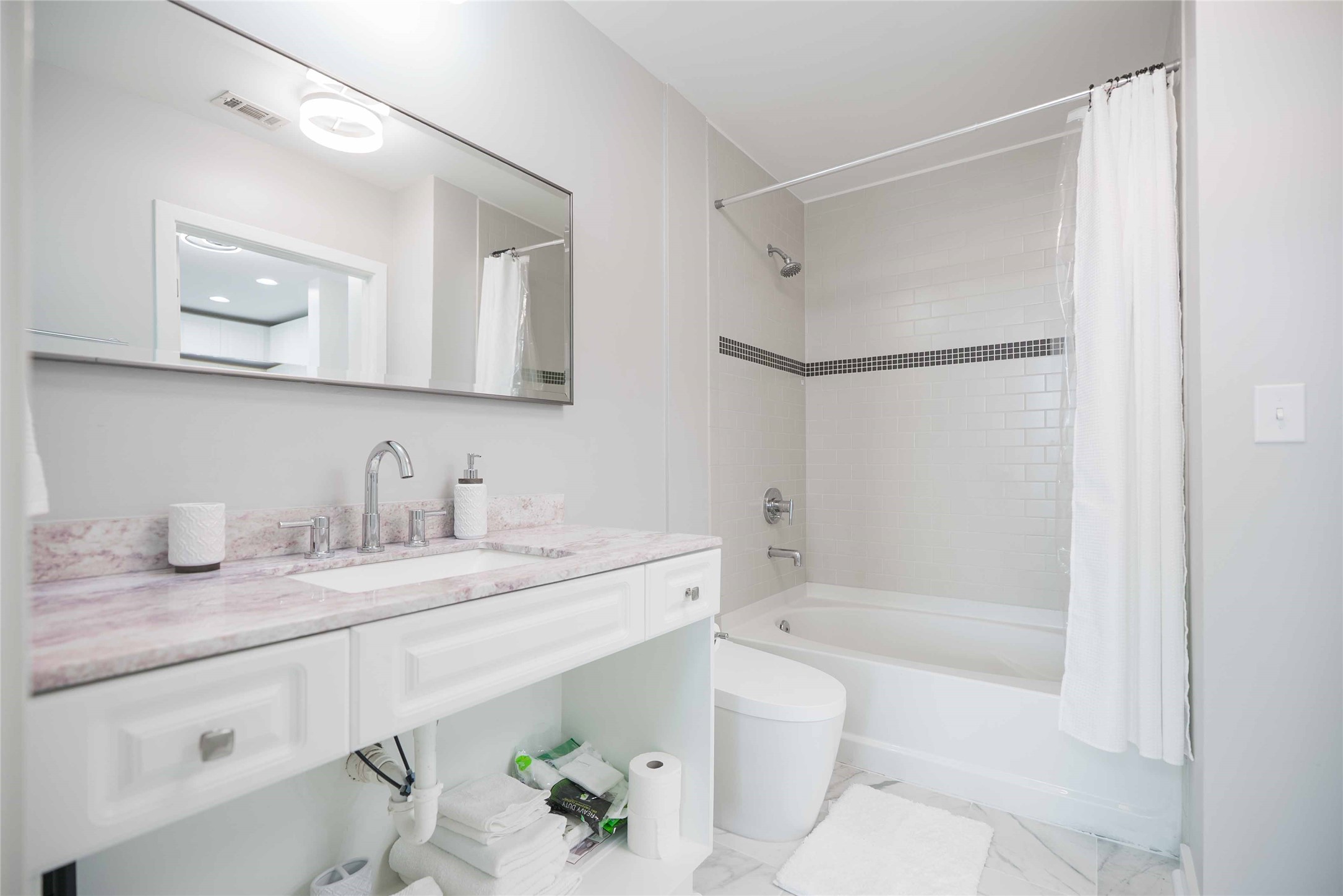5925 Almeda Road, Unit 12005 Houston, TX 77004 - Photo 19 of 25 a bathroom with a granite countertop sink mirror toilet and bathtub