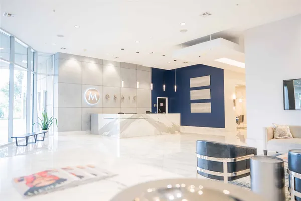 a large room with a large window and furniture