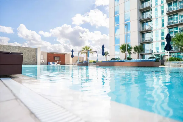 a view of swimming pool with outdoor seating and city view