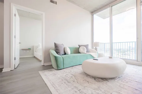a living room with furniture and a large window