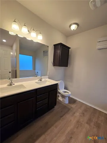 a bathroom with a double vanity sink and a mirror