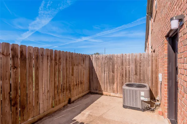 a view of a backyard with wooden fence