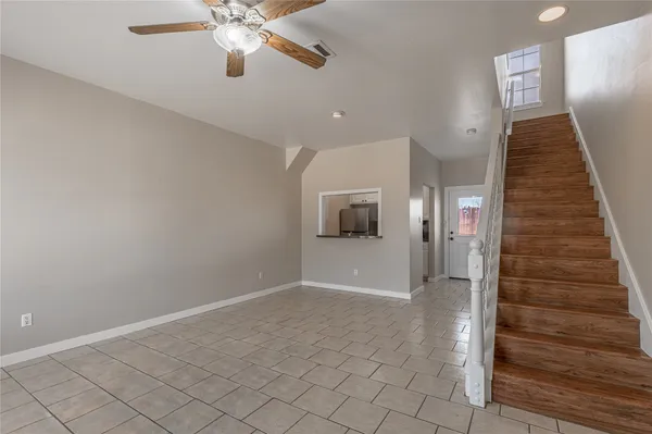 a view of a hallway with a chandelier fan and entryway