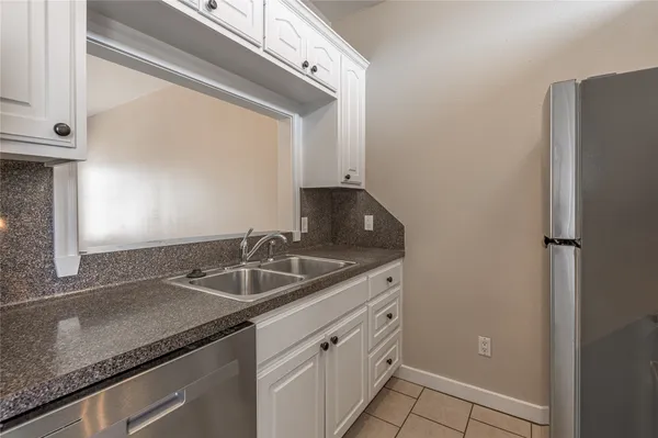 a sink with granite countertop a sink and cabinets