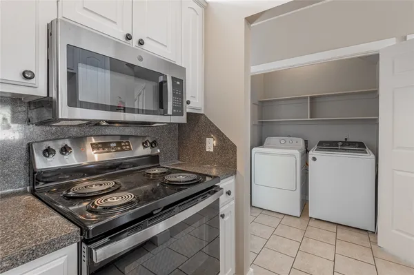 a stove top oven sitting inside of a kitchen