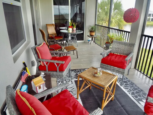 a living room with furniture and floor to ceiling windows