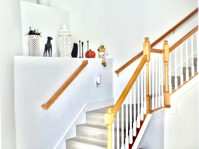 a kitchen with a refrigerator a stove a sink a dining table and chairs