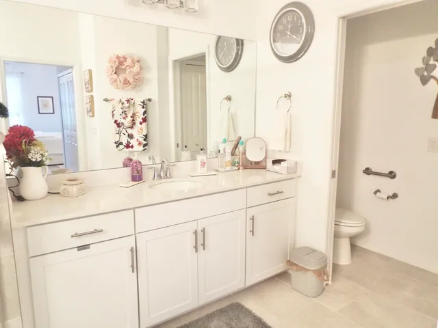 a bathroom with a sink mirror and shower
