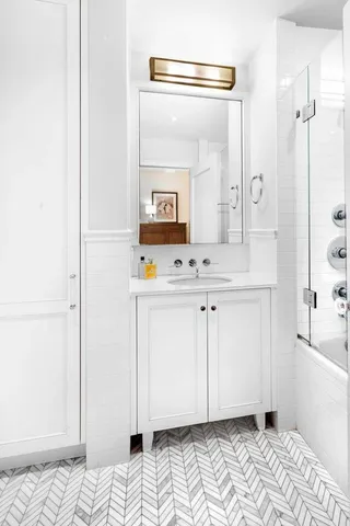 a bathroom with a sink a mirror and shower