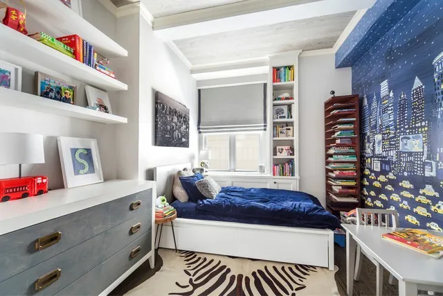 a living room with a couch and bookshelf