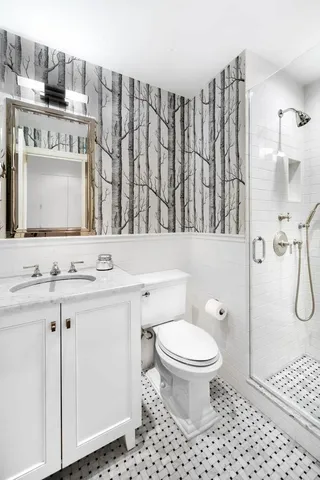 a bathroom with a sink a toilet and a mirror