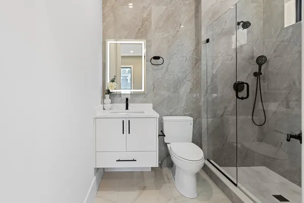 a bathroom with a toilet sink and shower