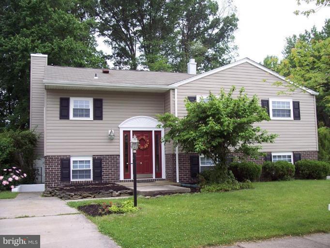 9219 Sandra Park Road Perry Hall, MD 21128 - Photo 1 of 11 a front view of a house with a yard and garage