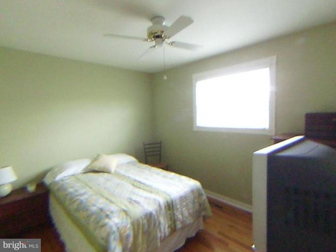 9219 Sandra Park Road Perry Hall, MD 21128 - Photo 5 of 11 a bedroom with a bed and a ceiling fan