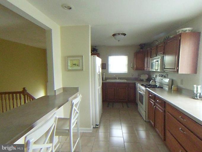9219 Sandra Park Road Perry Hall, MD 21128 - Photo 8 of 11 a kitchen with granite countertop lots of counter top space and dining table